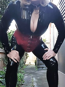 Rachel wears a catsuit and a red corset