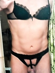 A hot babe is posing naked on the yard showcasing her assets